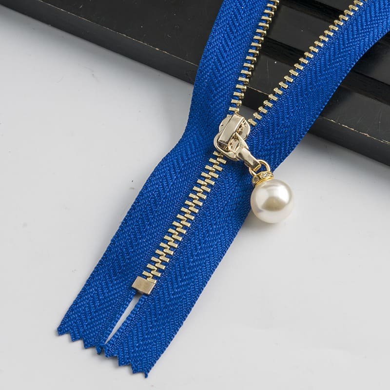 Gold mmetal zipper with large brass zipper teeth for a black jacket