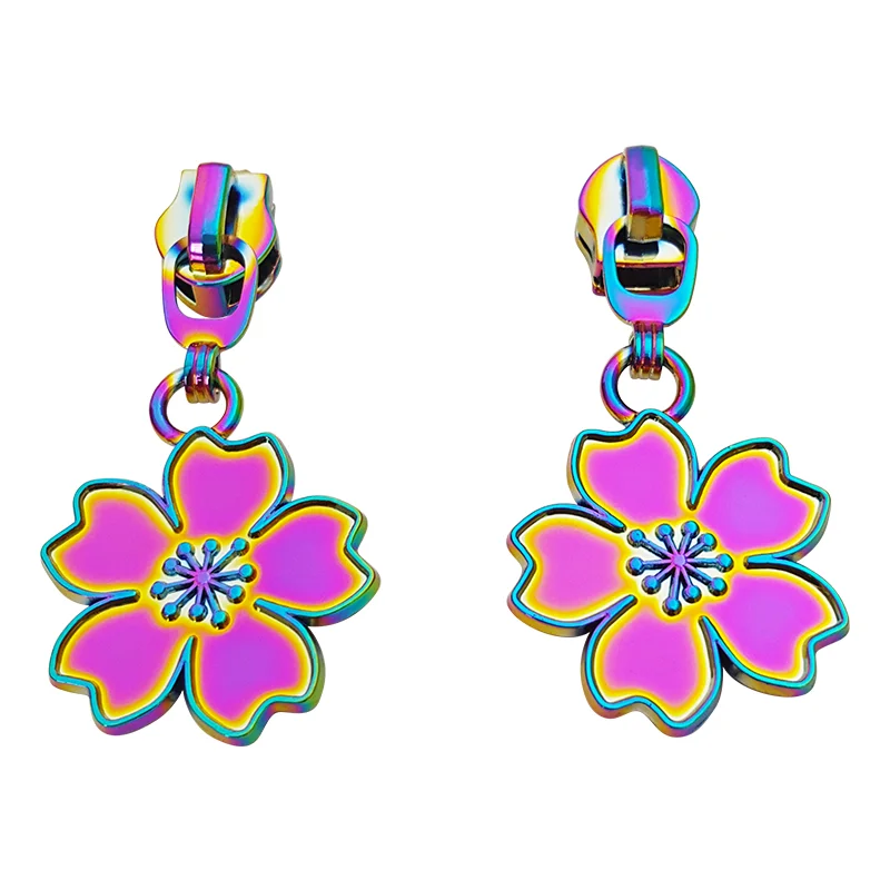 Two colorful zipper pulls designed as flowers with a vibrant rainbow finish, ideal for garment and bag accessories.