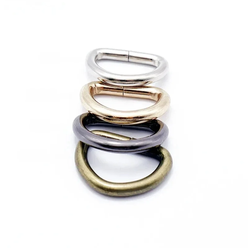 Four metal bag buckles in silver, gold, black, and bronze finish shown in vertical alignment against a white background.