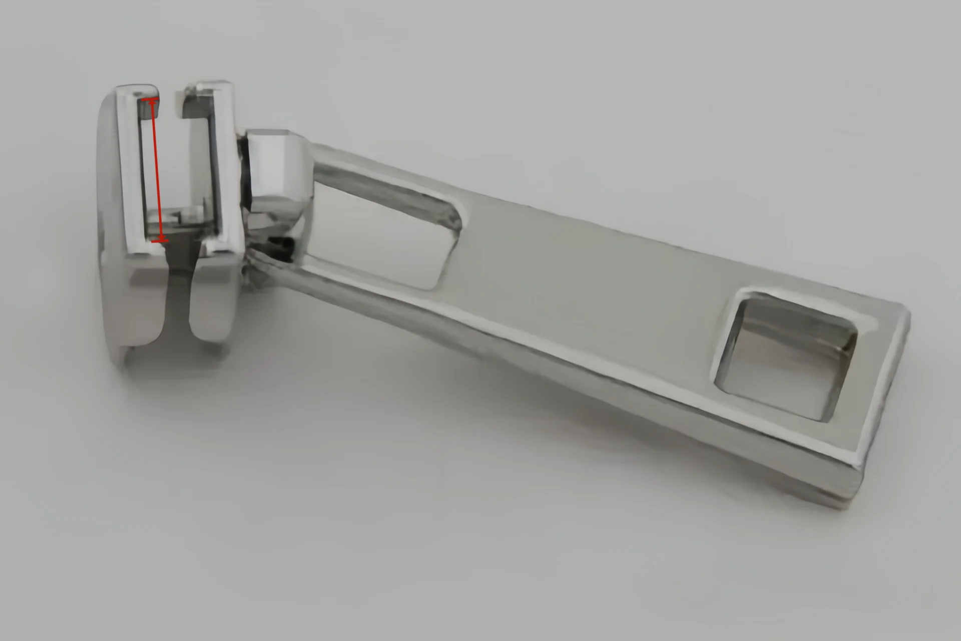 A shiny metal zipper puller with a rectangular design and a side view angle highlighting its polished surface and modern aesthetics.