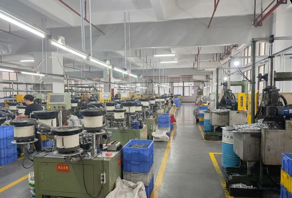 Automated machinery in a Shenzhen textile manufacturing factory with multiple spinning and processing units and a worker managing operations.