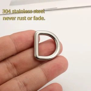 A hand holding a shiny, 304 stainless steel D-ring, known for its durability as it never rusts or fades.